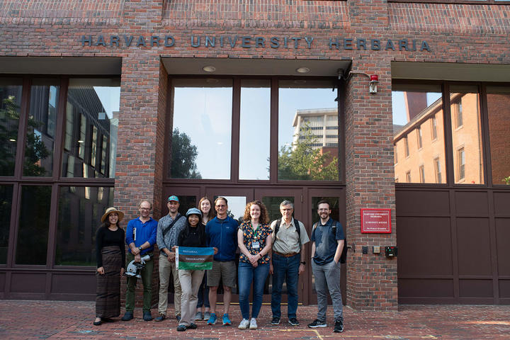 Paleobotanical curatorial team poses with collaborators from the National Geographic Society in front of the HUH building